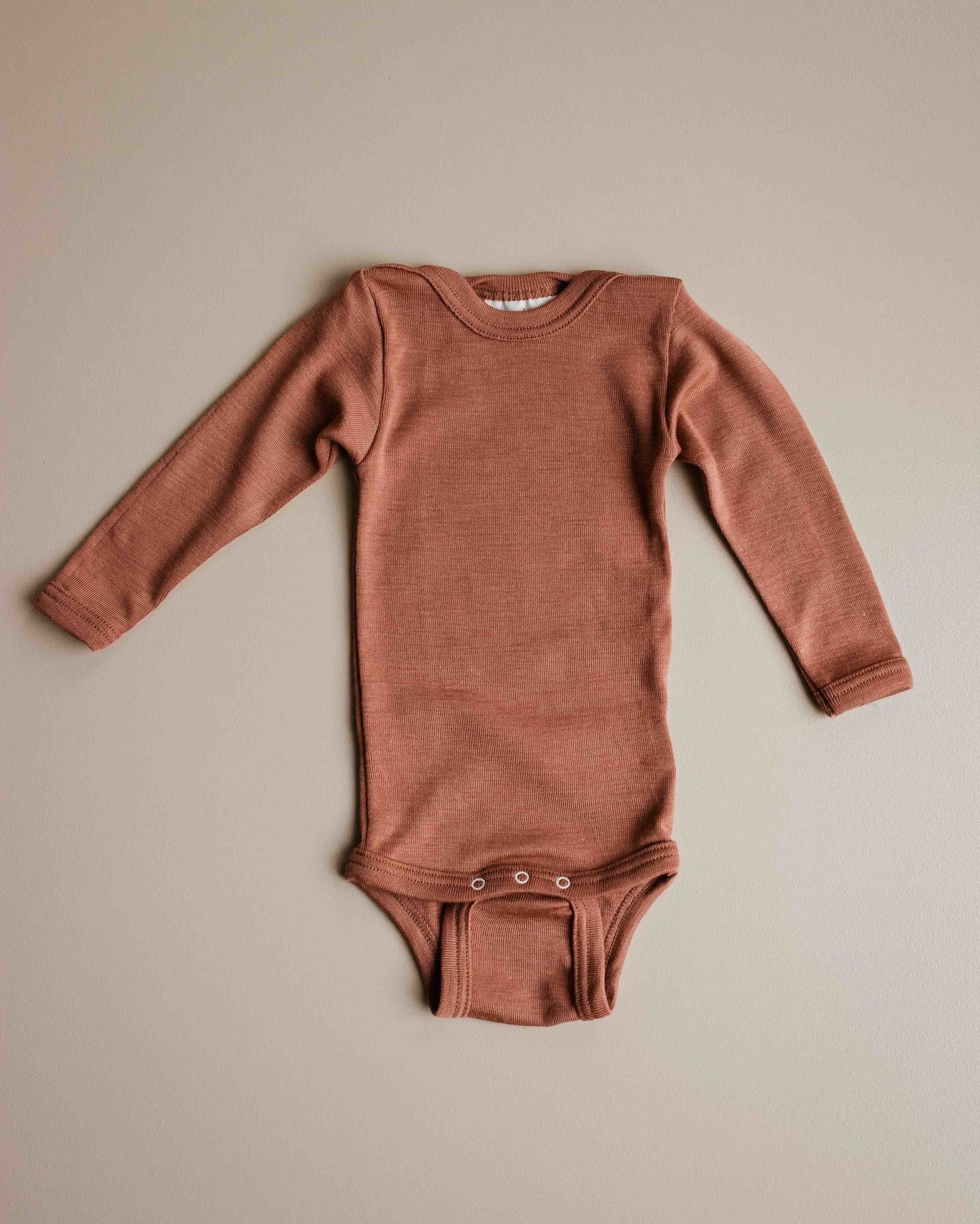 unaduna-sienna-clay-baby-body-long-sleeve-wool-sil